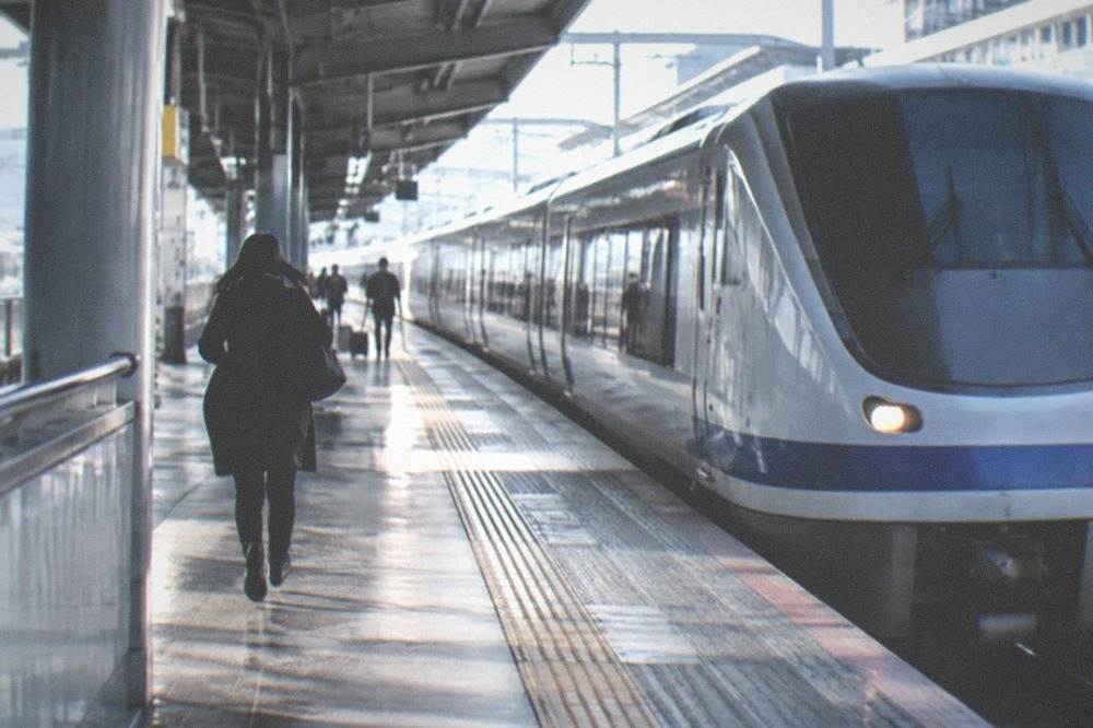 An airport express train waiting on a station platform at Kansai International Airport