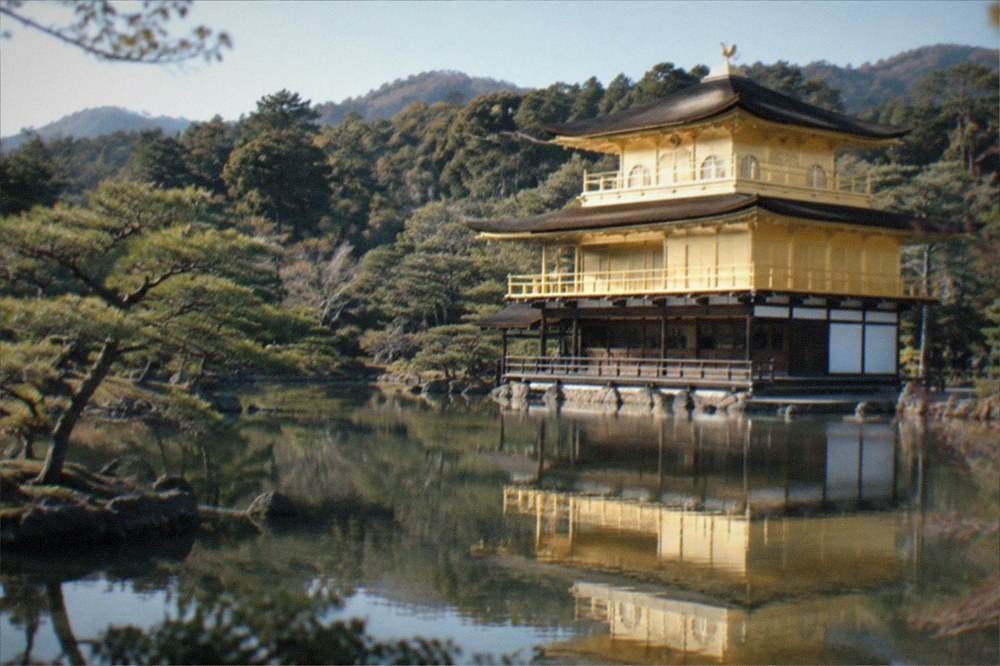 The Golden Pavilion reflected in the pond at Kinkaku-ji under a clear sky