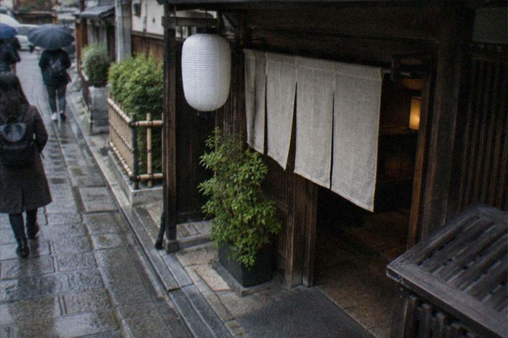 Traditional wooden restaurant entrance with noren curtain in Kyoto