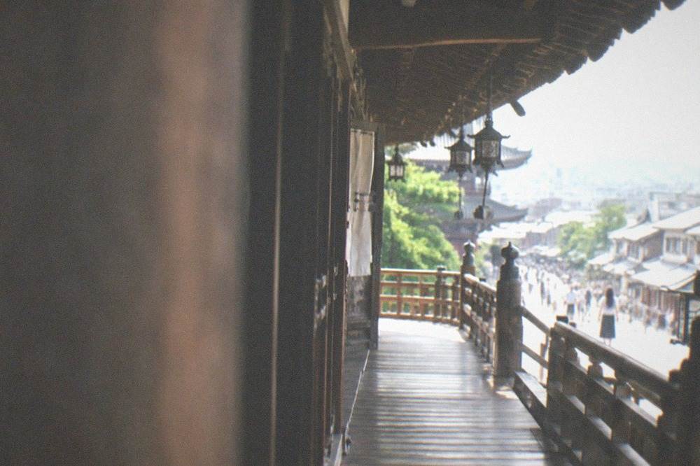 Long wooden corridor of a Kyoto castle palace seen from under its eaves