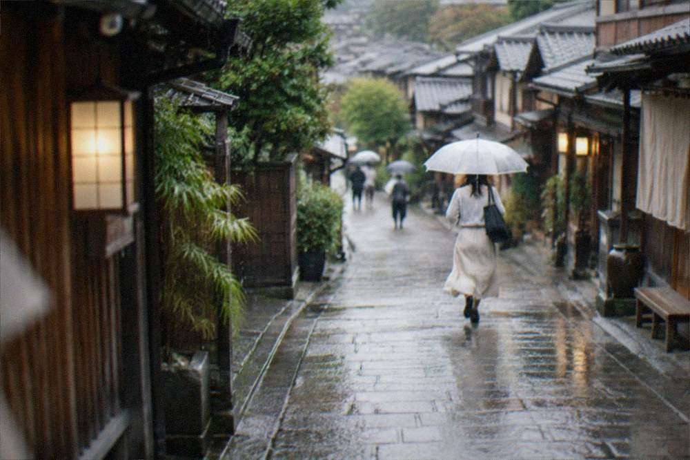 Rain falling on the stone-paved lanes and traditional shopfronts of Higashiyama in Kyoto